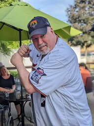Rich Larson, in a Minnesota Twins baseball jersey and hat, holds a batter up stance.Picture